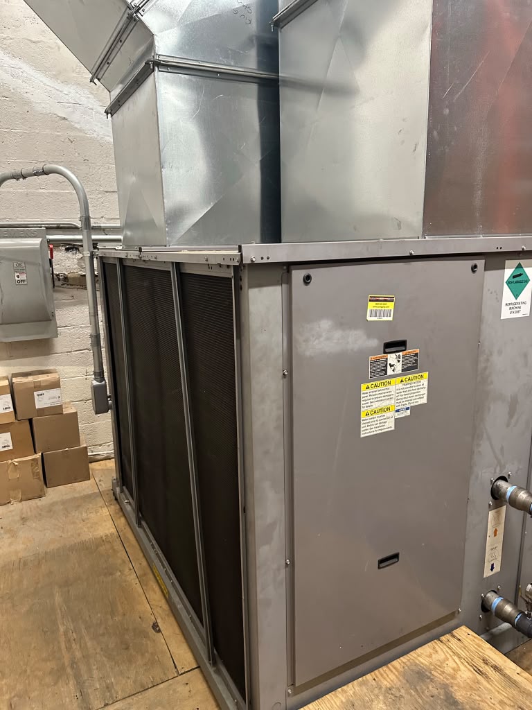 Commercial air handler and supply duct in a mechanical room