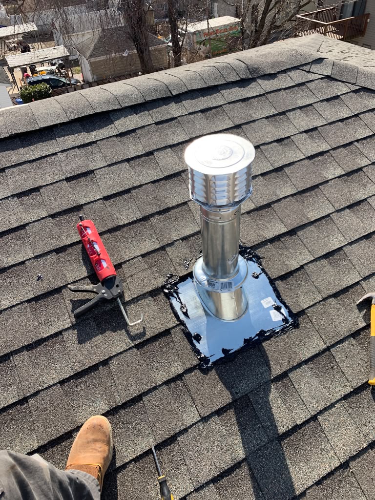 New roof vent flashed and sealed during a furnace venting job