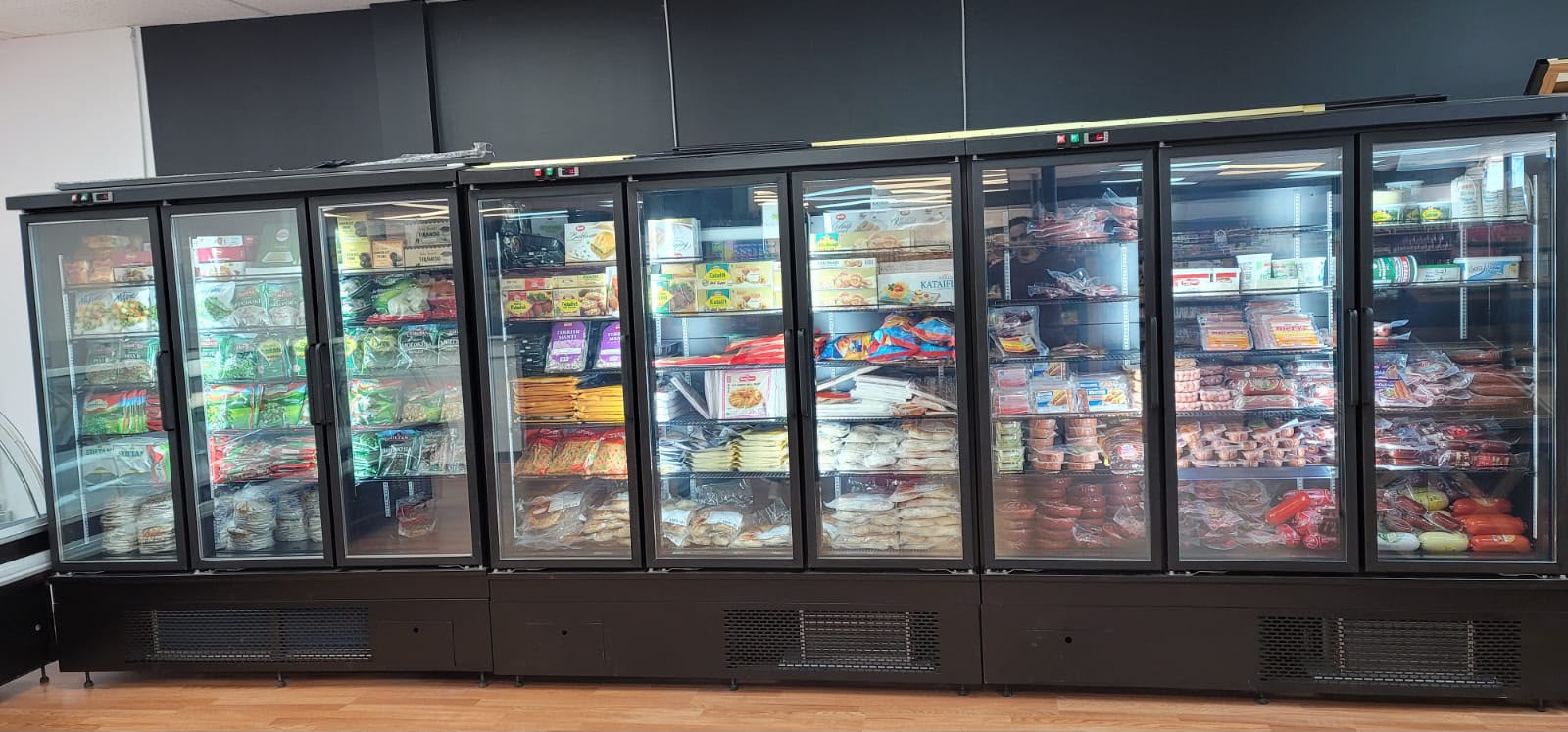 Commercial glass-door refrigeration cases installed in a market