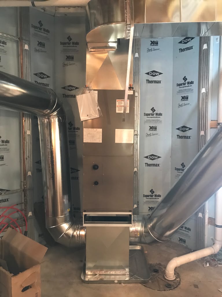 Vertical air handler with insulated supply and return duct connections