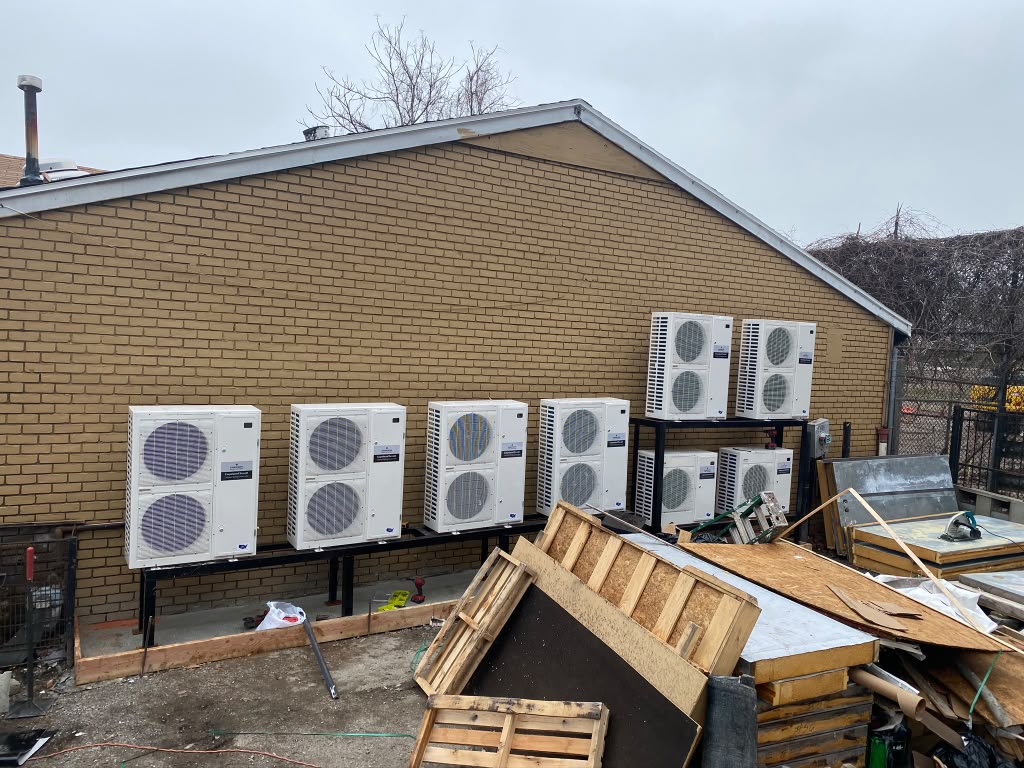Bank of eight mini split condensers mounted on a commercial wall rack